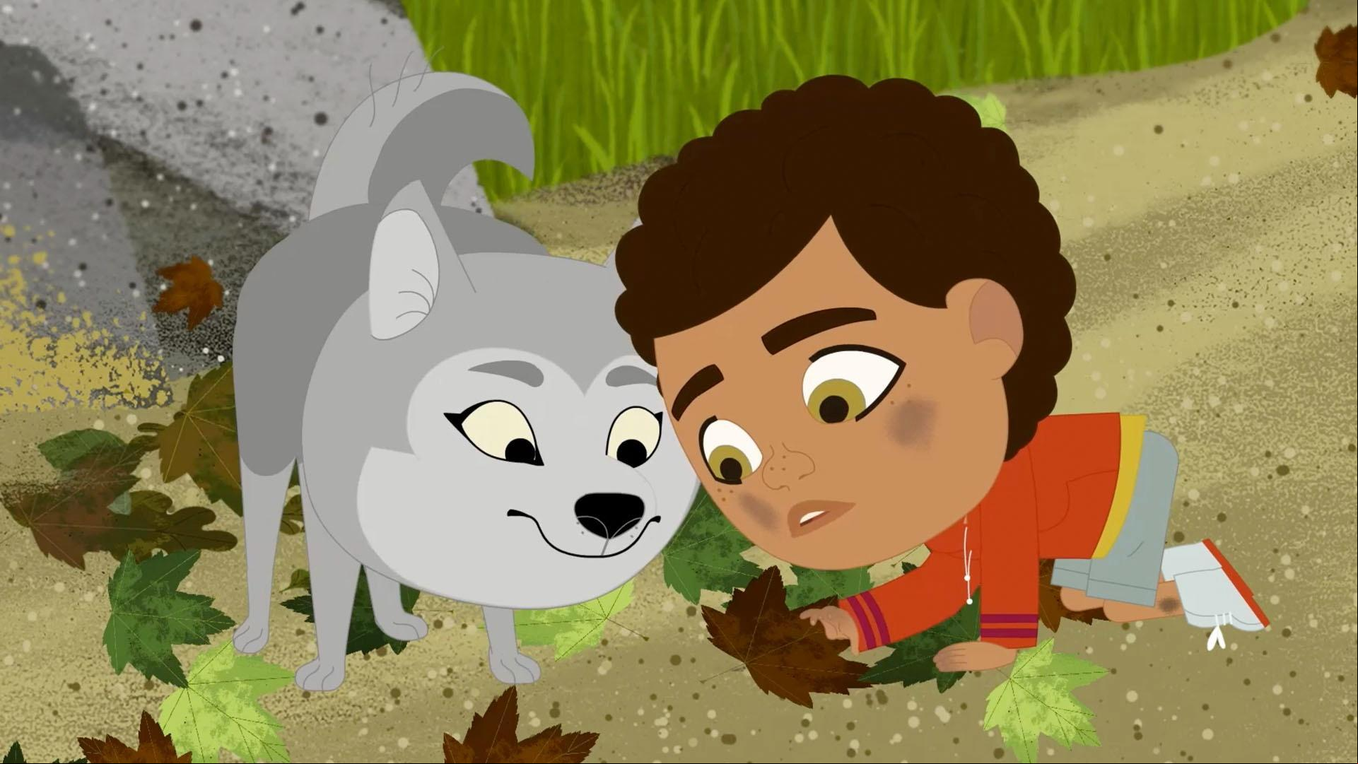 Looking at the ground near a rock, Rider and Wolfie find a family of roly poly bugs.