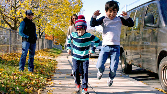 Two boys doing a long jump