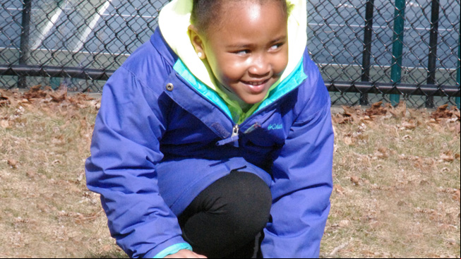 Girl crouches with ball