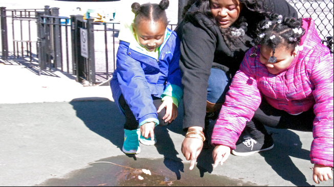 Mother and kids pointing to water