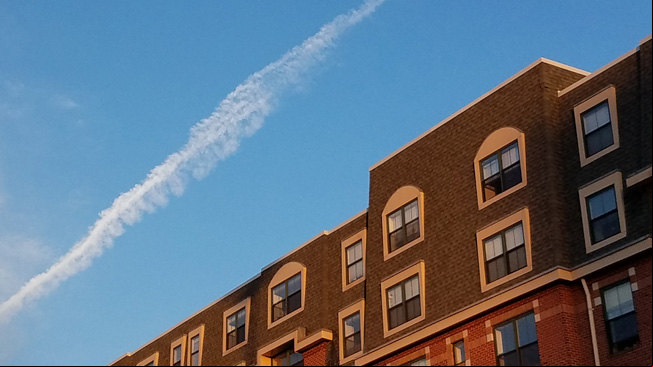 Contrails over building