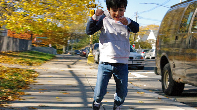 Boy jumps puddle