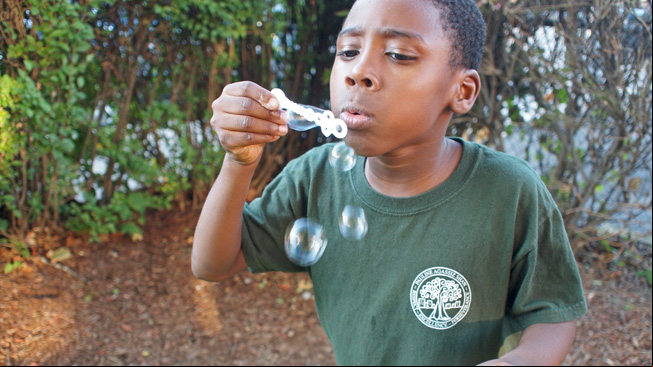 Boy blowing bubbles