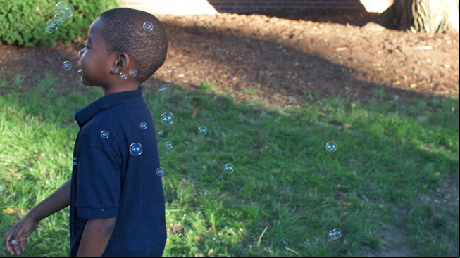 Boy playing with bubbles